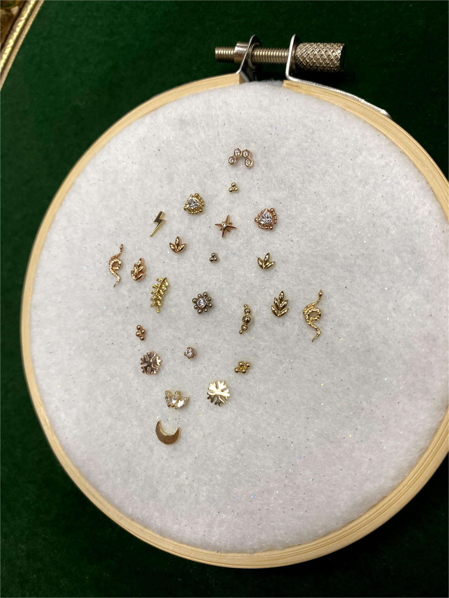 Photo of earrings on an embroidery loop.