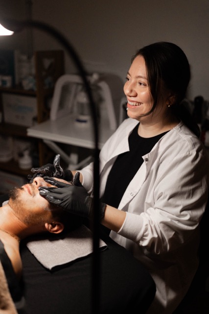 Photo of an aesthetician giving a facial.