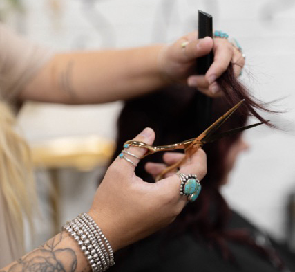 A client getting her hair cut at the salon.