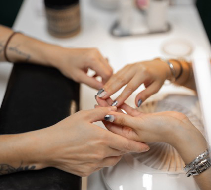 Photo of a client getting her nails done.